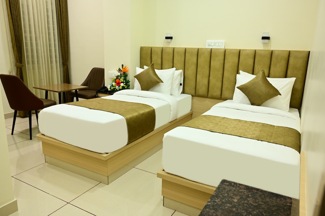 Premium Executive Twin room at SR Grand Hotel Tumkur — two single beds with Smart TV and AC at ₹2,950/night