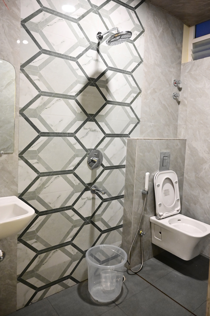 Clean en-suite bathroom at SR Grand Hotel Tumkur — premium fittings and hygienic facilities