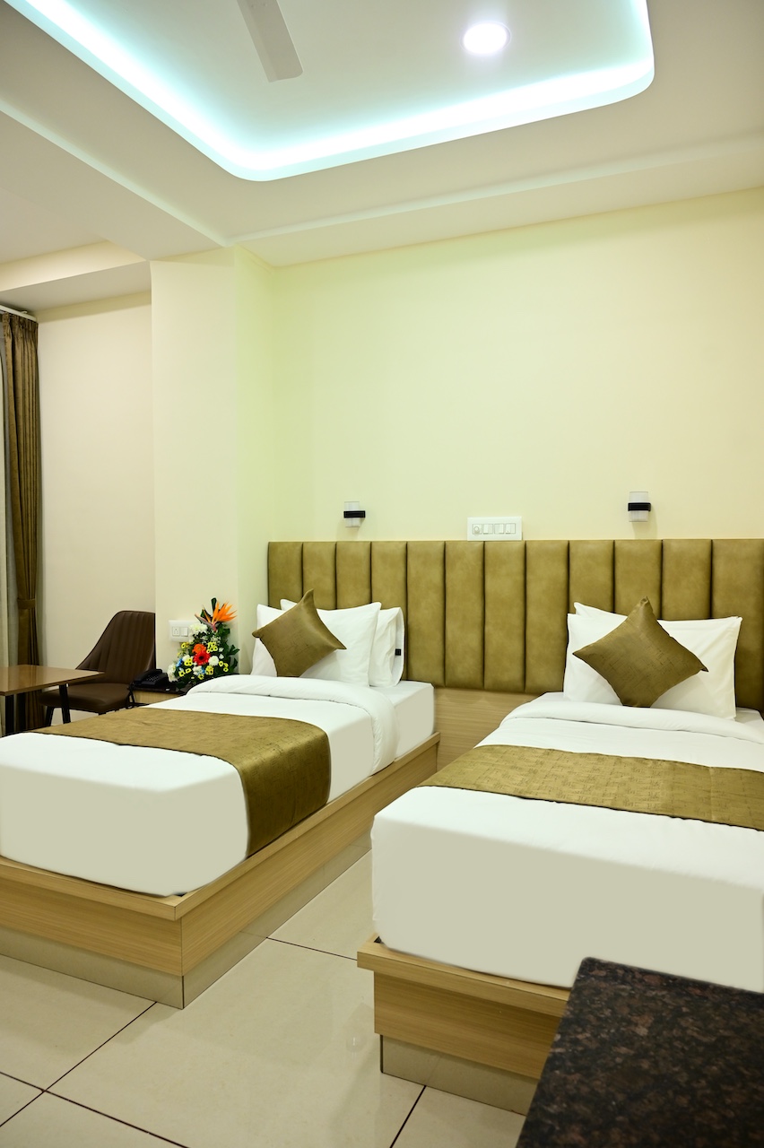 Premium AC room interior at SR Grand Hotel, Tumkur — clean, furnished with Smart TV and WiFi