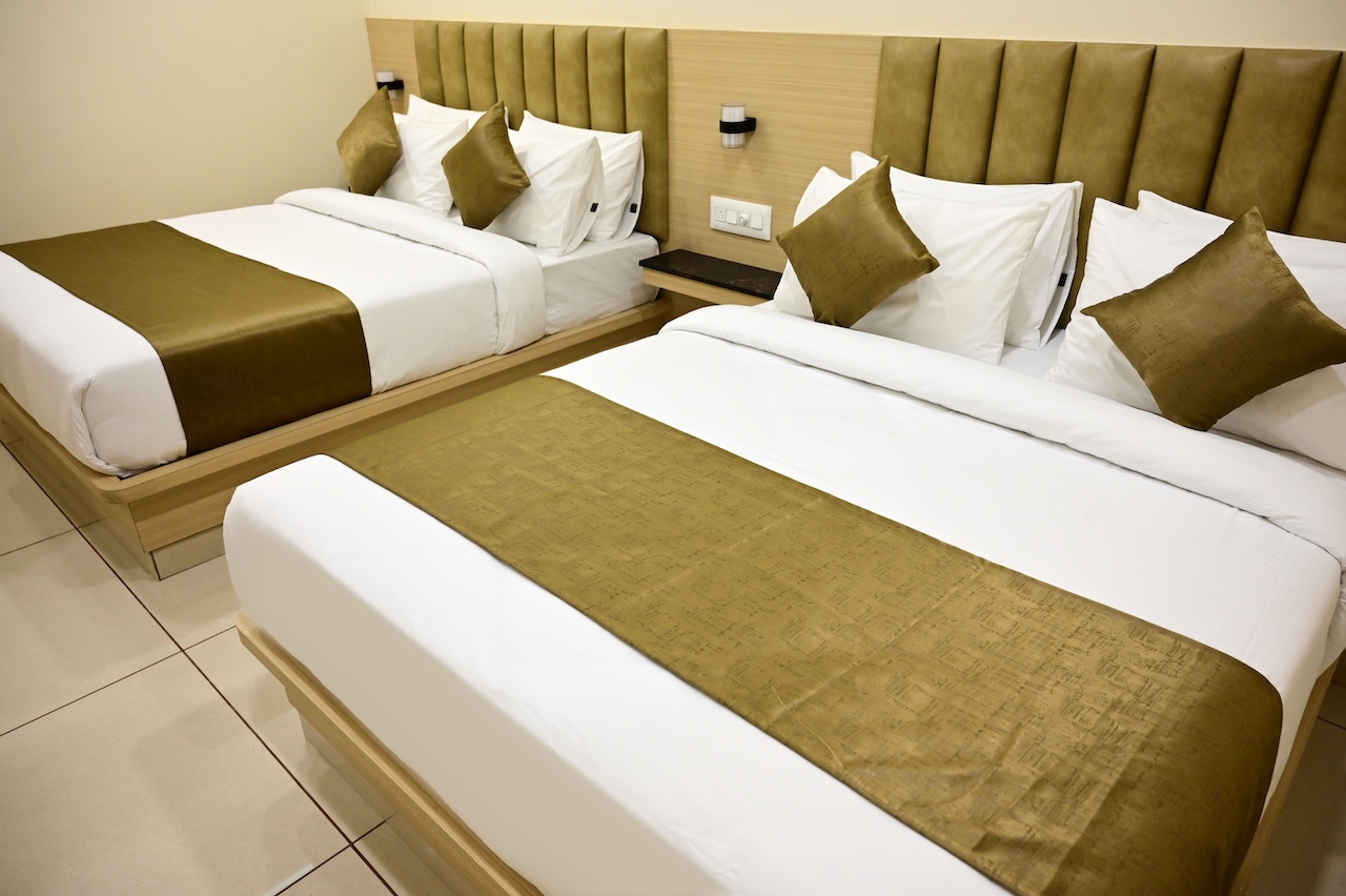 Premium twin bed room at SR Grand Hotel Tumkur — two single beds with AC and free WiFi