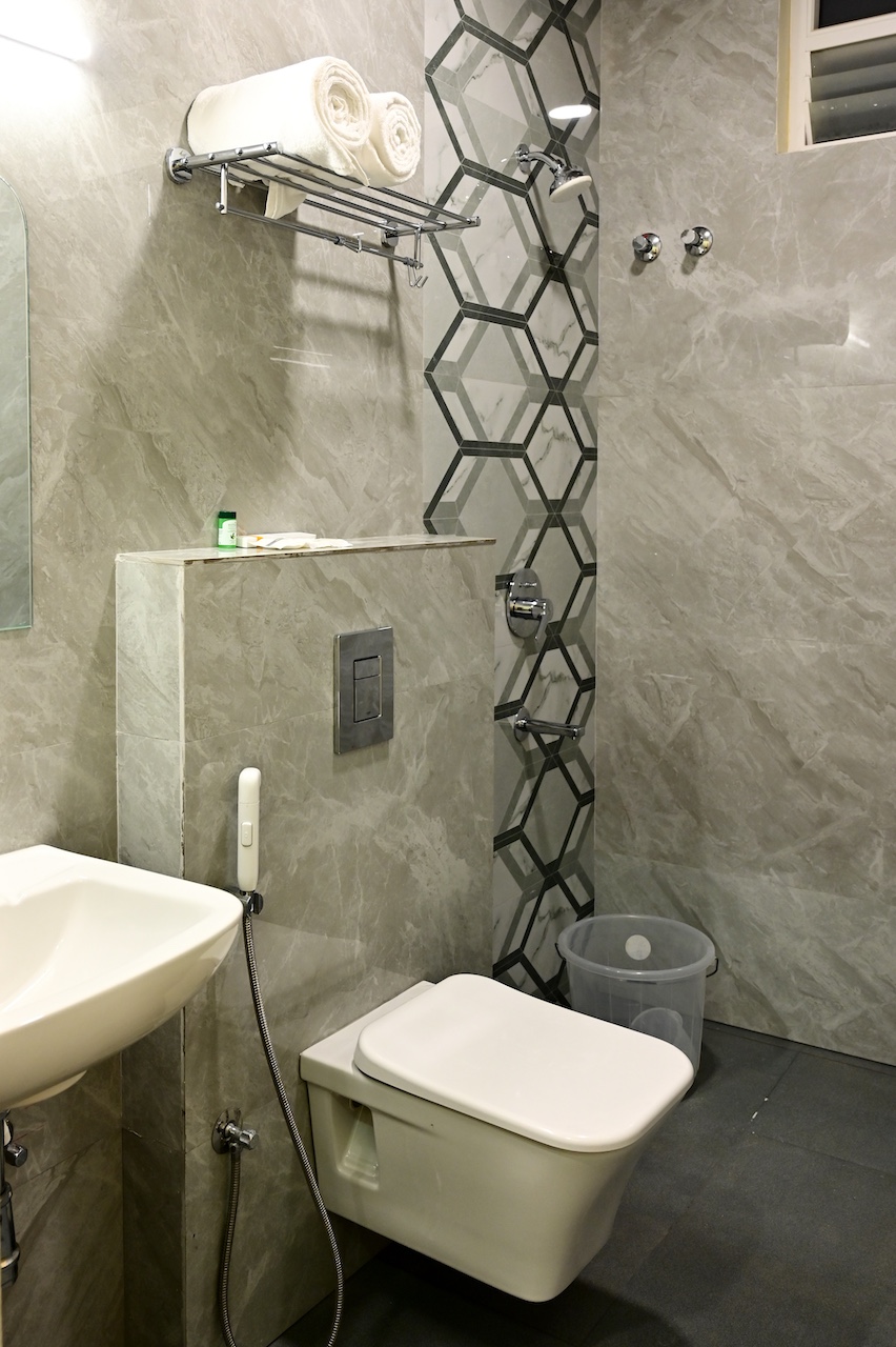 Clean en-suite bathroom at SR Grand Hotel Tumkur — premium fittings and hygienic facilities